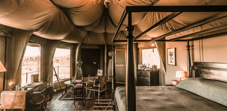 Tented suite bedroom with desert view at Zannier Hotels Sonop, Namibia